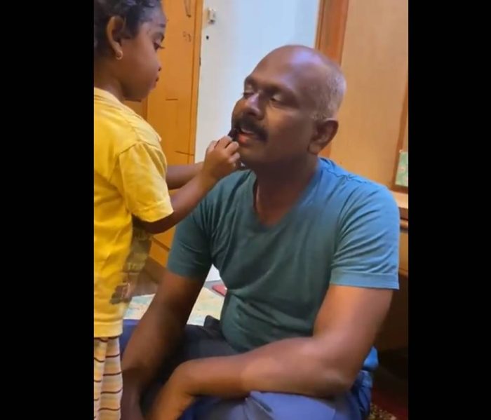 daughter doing makeup of father 